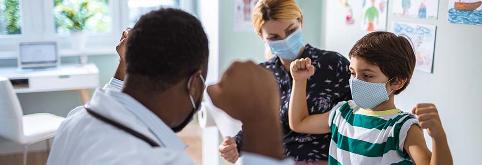 A doctor and nurse provide pediatric services to a young patient