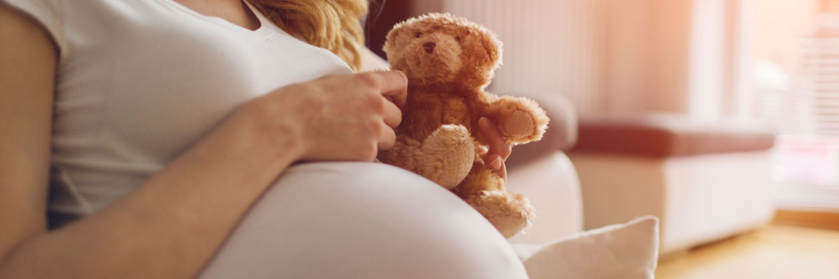 pregnant woman with teddy bear